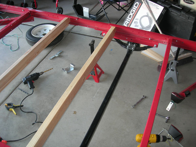 Notched 2x4 crossmembers laid across the frame