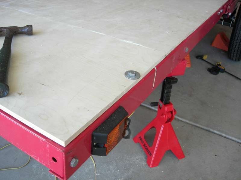 Bolting the floor to the trailer frame with large washers