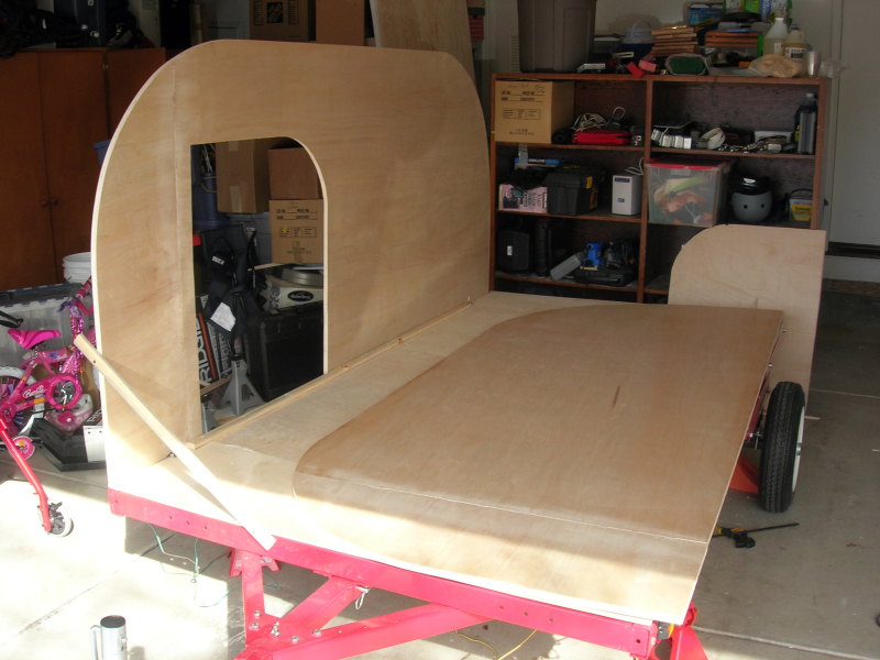The first plywood side wall standing on the floor