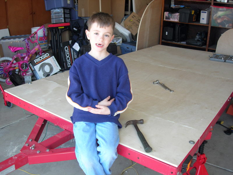 Justin sitting on the bare floor of the trailer