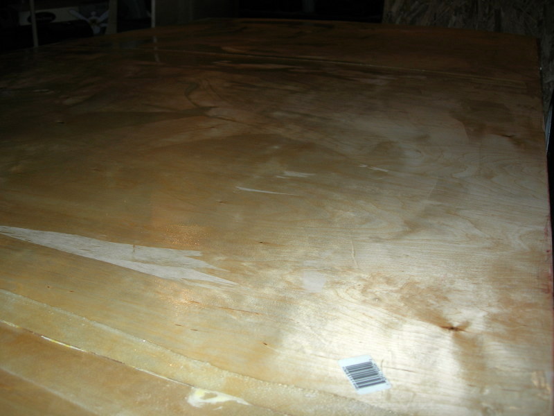 Close-up of wet epoxy over a fiberglass-taped seam